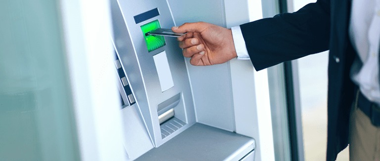 Banner Image of a Businessman Using a Cashpoint