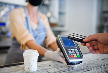 Banner Image of Customer Using Contactless Payment to Pay for Coffee 