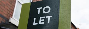 Banner Image of Landlord Holding Key to Rental Property